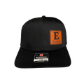 Black cap with orange and white logo on a light gray background