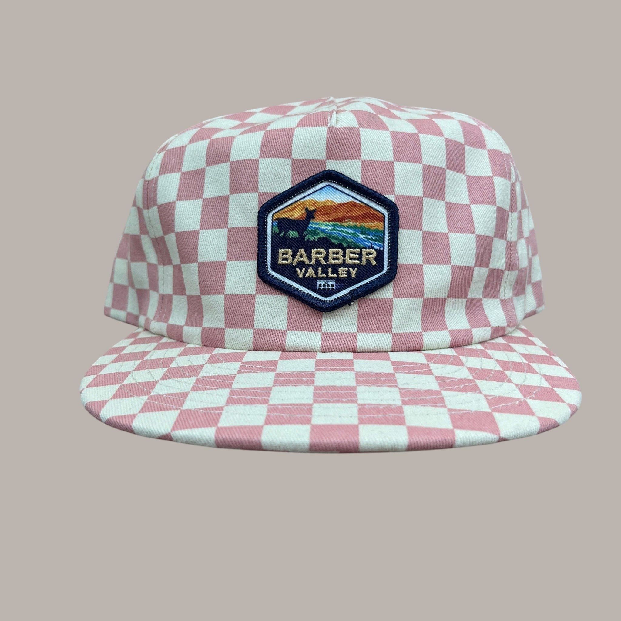 Barber Valley Threads pink and white checkered snapback hat with a custom embroidered landscape patch on the front.