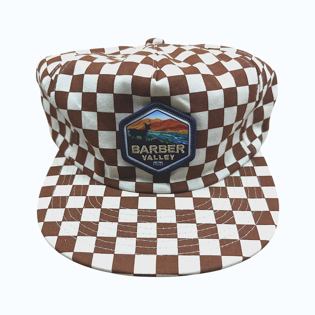 Barber Valley Threads brown and white checkered snapback hat with a custom embroidered landscape patch on the front.